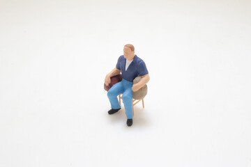 Small Miniature Figure Figure Seated on Chair