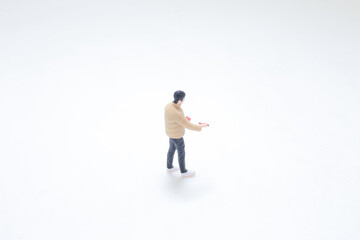 Obraz premium Miniature Figure Wearing Gloves Standing