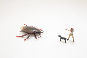 Miniature Figures Facing a Large Cockroach i