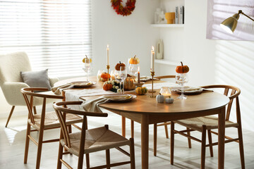 Stylish dining room with beautiful table setting and autumn decor