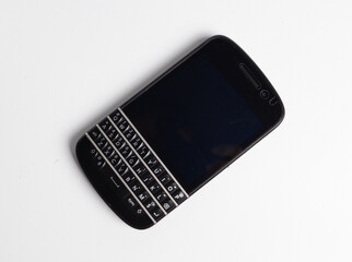 Old mobile phone with black screen, isolated on white.