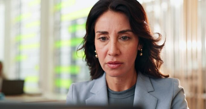 Online, serious and woman with laptop, office and research for insurance rates, reading and actuary. Corporate, financial report and analysis for investment, web and person with info for business