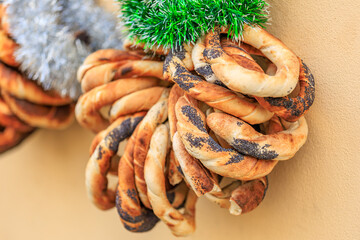 A bunch of bread with pikelets on them hanging from a wall