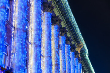 Colorful blue led lights decorating historic building facade at night