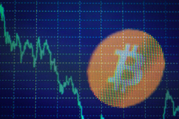 Bitcoin price decline on digital chart display with emphasized logo