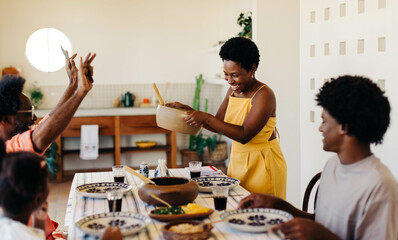 Happy Brazilian family enjoying traditional home-cooked food together