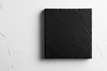 Slate board resting against a textured white wall showcasing its natural elegance and simplicity in a contemporary setting
