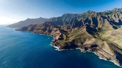Obraz premium An aerial view of the rugged cliffs and blue ocean 