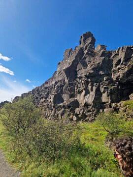 Standing beneath the towering basalt formations of &THORN;ingvellir National Park, Iceland, where the North American and Eurasian tectonic plates pull apart.