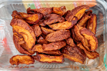 Close-up of dehydrated apple slices in a clear container