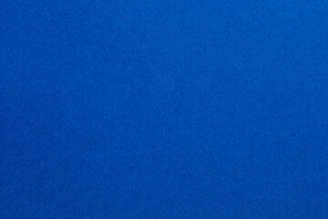 A blue background with a few white dots, textured origami paper backdrop