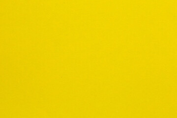 A yellow background with no visible objects, textured origami paper backdrop