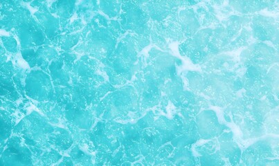Obraz premium Clear Turquoise Water Surface with Gentle Waves and Foamy Patterns