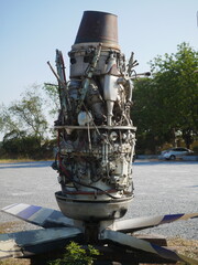 A broken airplane engine is found outside a junk shop in Thailand.