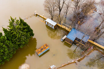 Land plot with outbuildings flooded during spring flood