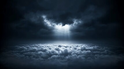 Obraz premium Dramatic sky with dark clouds and rays of light breaking through, creating a mystical atmosphere