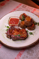 Beautiful restaurant dish golden potatoes and juicy meat, beautiful food photo