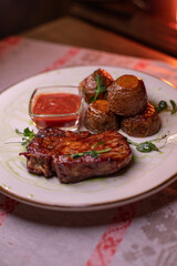 Beautiful restaurant dish golden potatoes and juicy meat, beautiful food photo