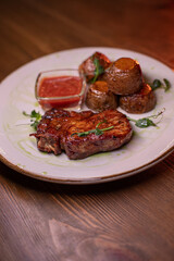 Beautiful restaurant dish golden potatoes and juicy meat, beautiful food photo