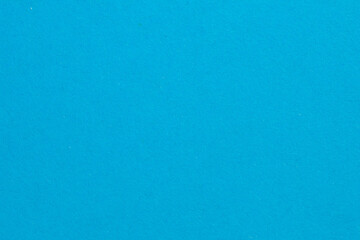 A blue background with a white dot in the middle, textured origami paper backdrop