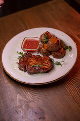 Beautiful restaurant dish golden potatoes and juicy meat, beautiful food photo