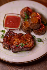 Beautiful restaurant dish golden potatoes and juicy meat, beautiful food photo