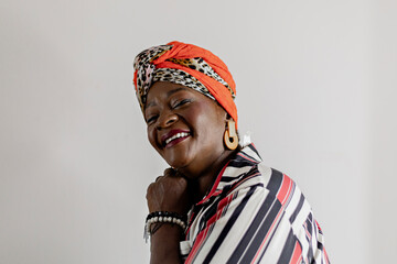 Fototapeta premium Beautiful woman in African clothes happy on a white background. Smiling, serious. Rio de Janeiro, Brazil.