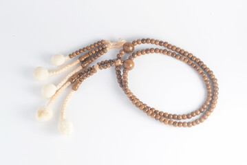A wooden Juzu, a Japanese prayer beads, is a form of beadwork used to count the repetition of prayers, chants or mantras by members of various religions such as Buddhism and Shinto.