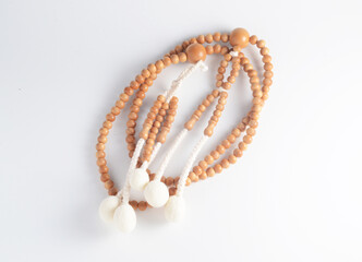 A wooden Juzu, a Japanese prayer beads, is a form of beadwork used to count the repetition of prayers, chants or mantras by members of various religions such as Buddhism and Shinto.