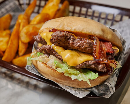 Juicy Double Cheeseburger with Bacon and Fries