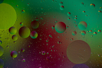 Oil and water abstract background. Oil bubbles floating on a colored background.