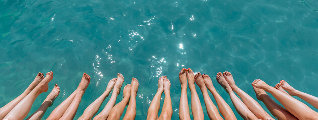 Photo from above of many girls' legs above blue sea water. Spa and swimming pool as entertainment...
