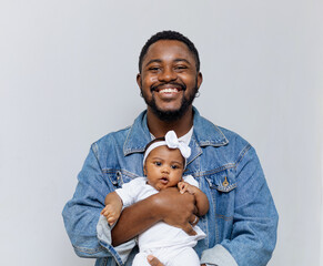 A happy young black father having moments of affection and care with his newborn daughter. Rio de...
