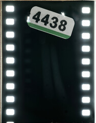 An empty vintage film negative, showing the beginning of the roll and a light-exposed section before the first exposure.