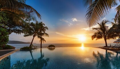 Obraz premium Breathtaking sunset over tranquil poolside with palm trees in summer season