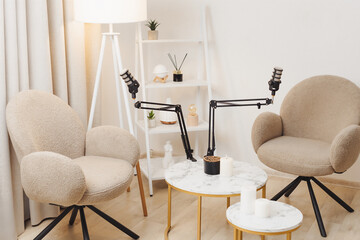 Cozy recording setup in a stylish living room with comfortable chairs and decorative elements