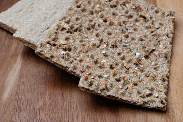 Crispy diet breadsticks on wooden surface