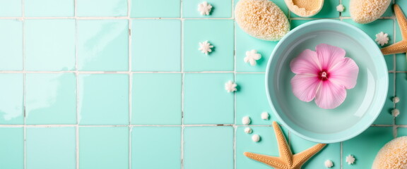 Spa elements with pink flower on turquoise tiles