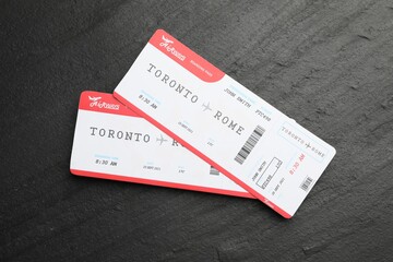 Travel agency. Flight tickets on dark textured table, top view