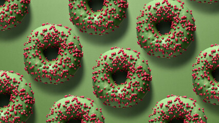 Creative background with green glazed donuts covered in red sprinkles on a green surface. A festive and modern design for creative projects