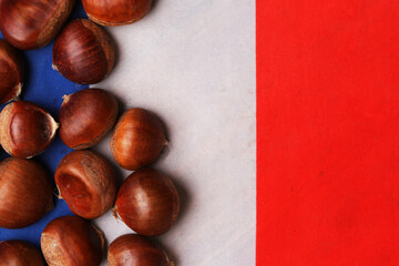 chestnuts on the background of the flag of France. Concept of traditional food of the French