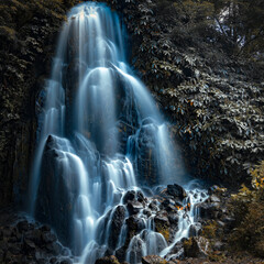 Ribeira dos Caldeirões is a stunning natural park on São Miguel Island, Azores, known for its lush greenery, picturesque waterfalls, historic watermills, and walking trails, offering visitors a serene