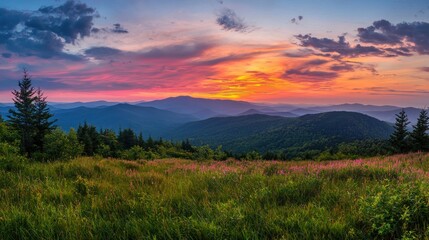 Obraz premium A distant mountain range meeting the horizon under a dramatic sky filled with vibrant colors of dusk