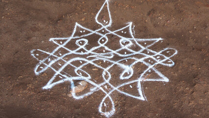 Traditional Indian folk art 'Kolam' rangoli drawn on the floor