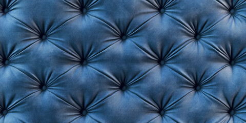 A quilted chambray blue abstract background with padded, tufted leather textures, creating a plush, elegant, and stylish visual effect.