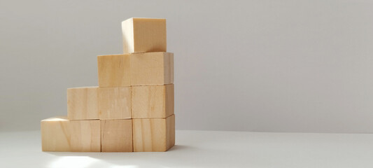Building blocks stacked in ascending order minimalist studio photography modern close-up concept of growth