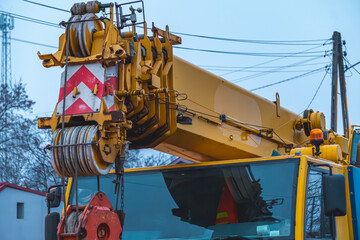 huge heavy yellow crane standing on the street during road renovation. road construction. crane in mud while lifting weights. crane mechanisms