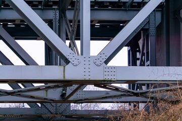 construction of a large railway bridge over the river. steel and metal bridge. rivets.