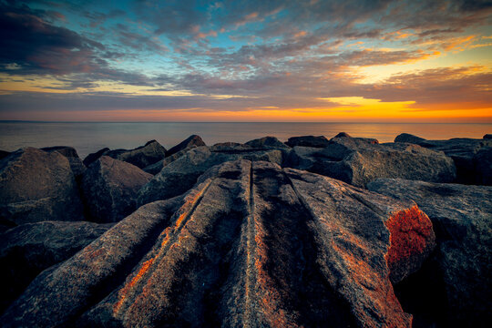 Close-up of a coastal rock wavebreaker  along the Baltic Sea at sunset, Lithuania