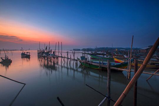 Boats moored in Tanjung Kait harbour at sunrise, Mauk District, Tangerang Regency, Banten, West Java, Indonesia